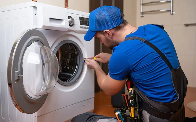 Technician doing washing machine repair at a home in Mumbai